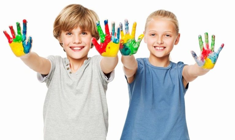 2 kids holding out hands with finger paint on both hands