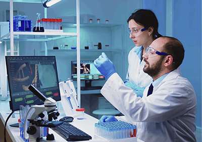 Scientists working in a lab and analyzing a batch of Human growth hormone solution