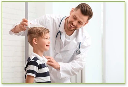 Growth Hormones for Kids image of Doctor measuring boy on height chart