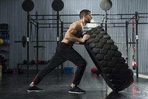 HGH for Body Buiilding man pushing tire